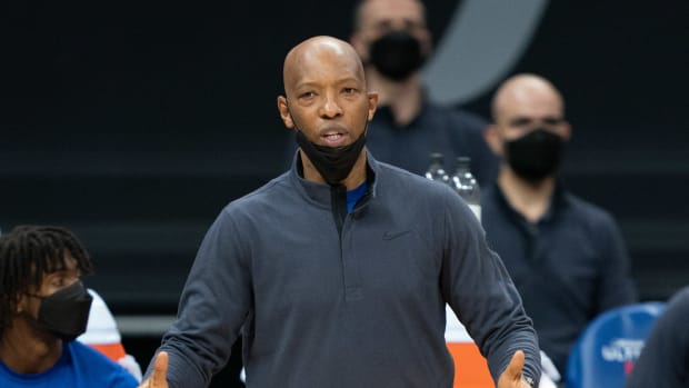 Sam Cassell stands on the sidelines.
